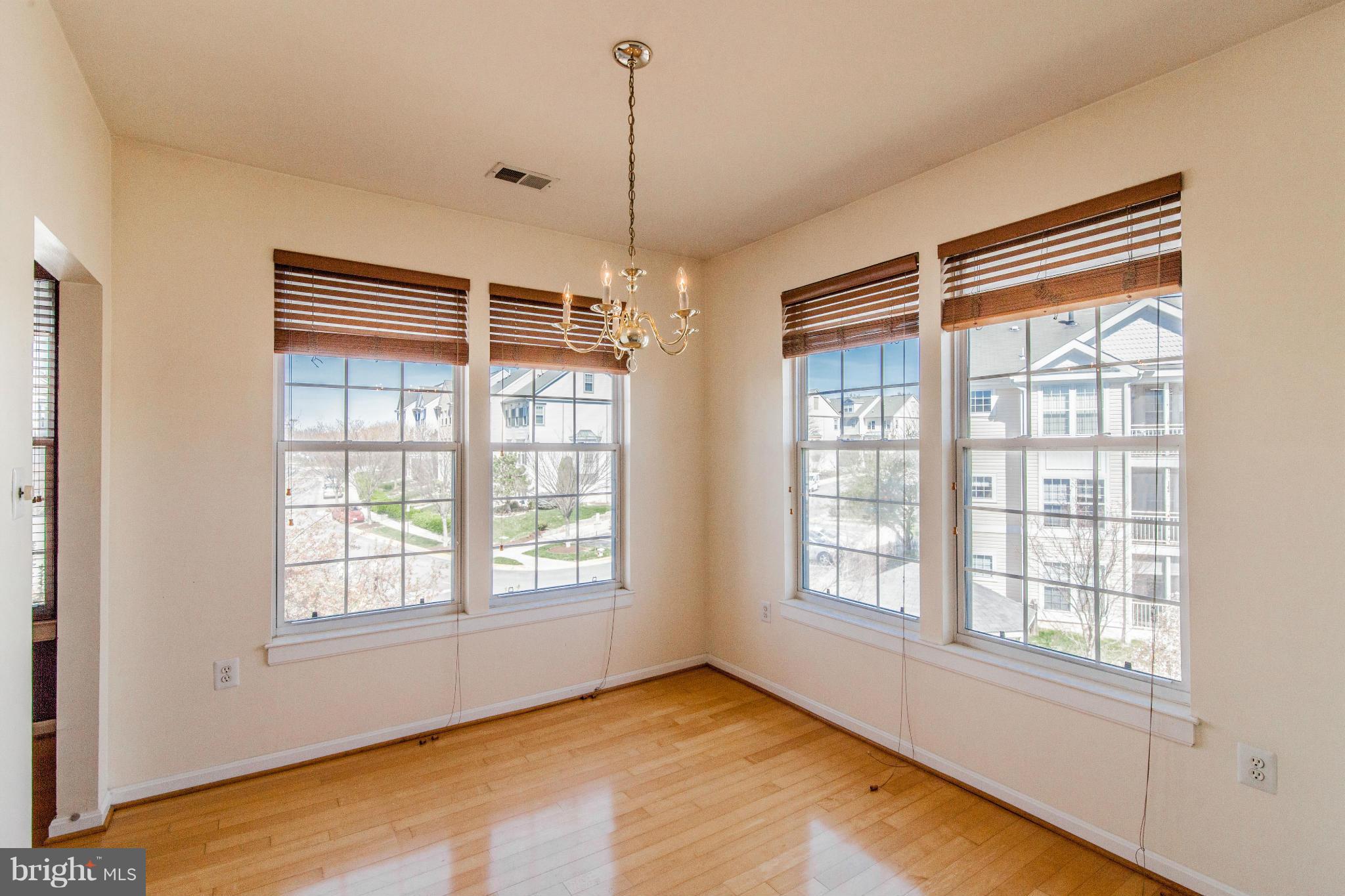 12008 Amber Ridge Circle, Unit A301 Germantown, MD 20876 - Photo 4 of 22 a view of an empty room with a window