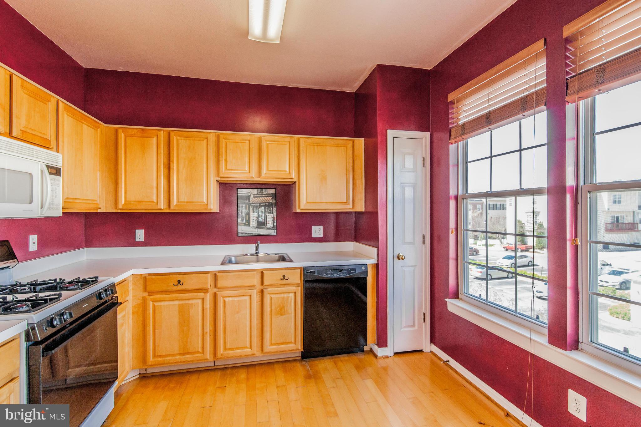 12008 Amber Ridge Circle, Unit A301 Germantown, MD 20876 - Photo 6 of 22 a kitchen with a stove a sink and a refrigerator