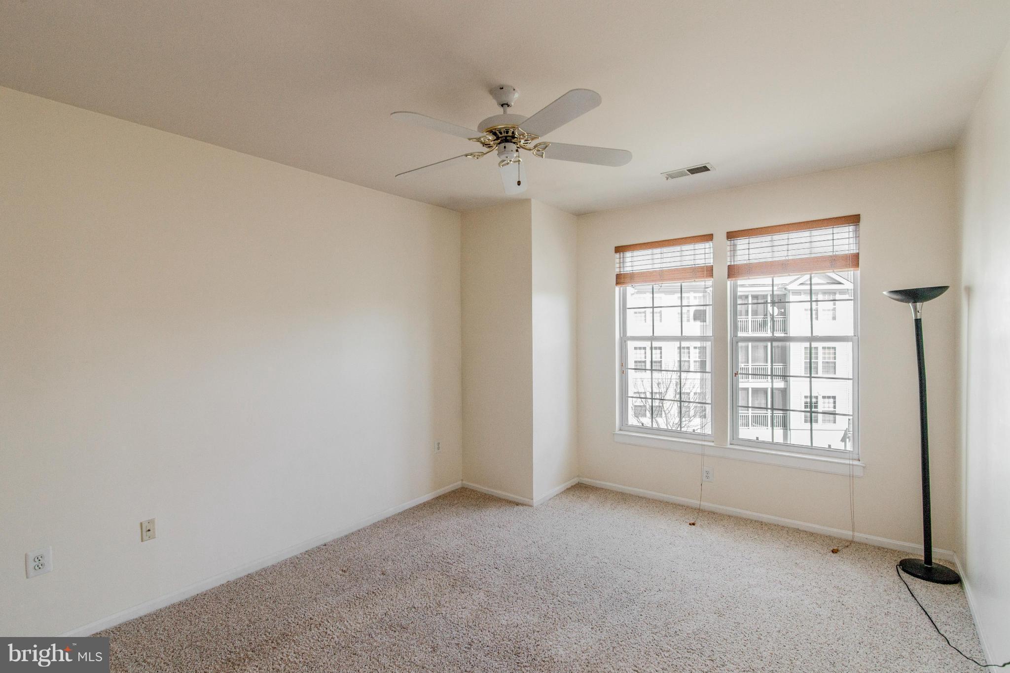 12008 Amber Ridge Circle, Unit A301 Germantown, MD 20876 - Photo 9 of 22 a view of an empty room with a window