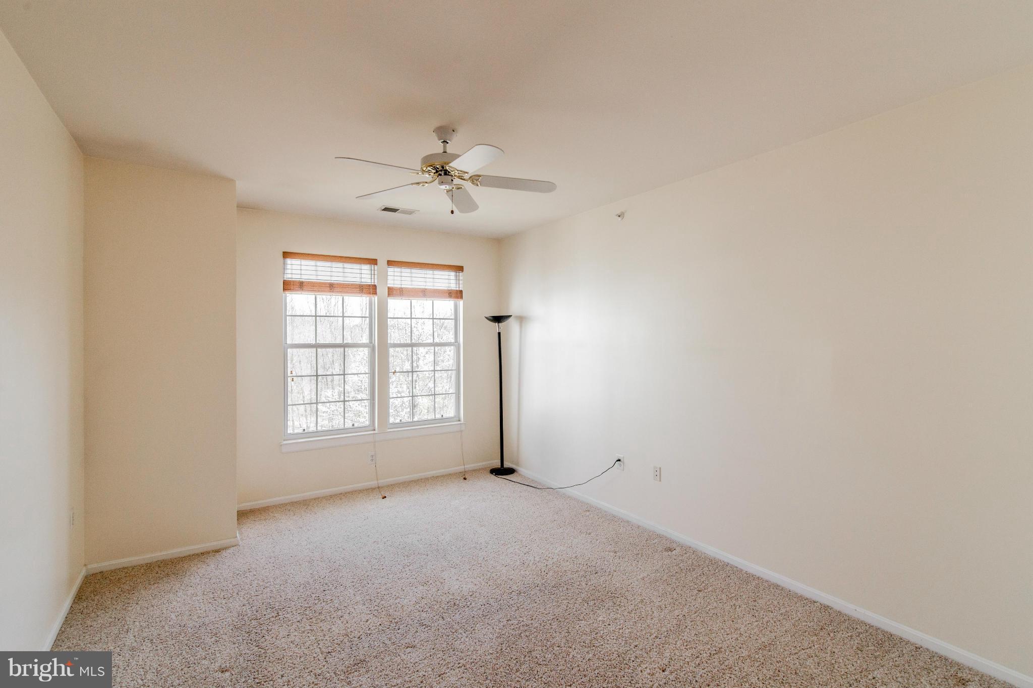 12008 Amber Ridge Circle, Unit A301 Germantown, MD 20876 - Photo 10 of 22 wooden floor in an empty room with a window