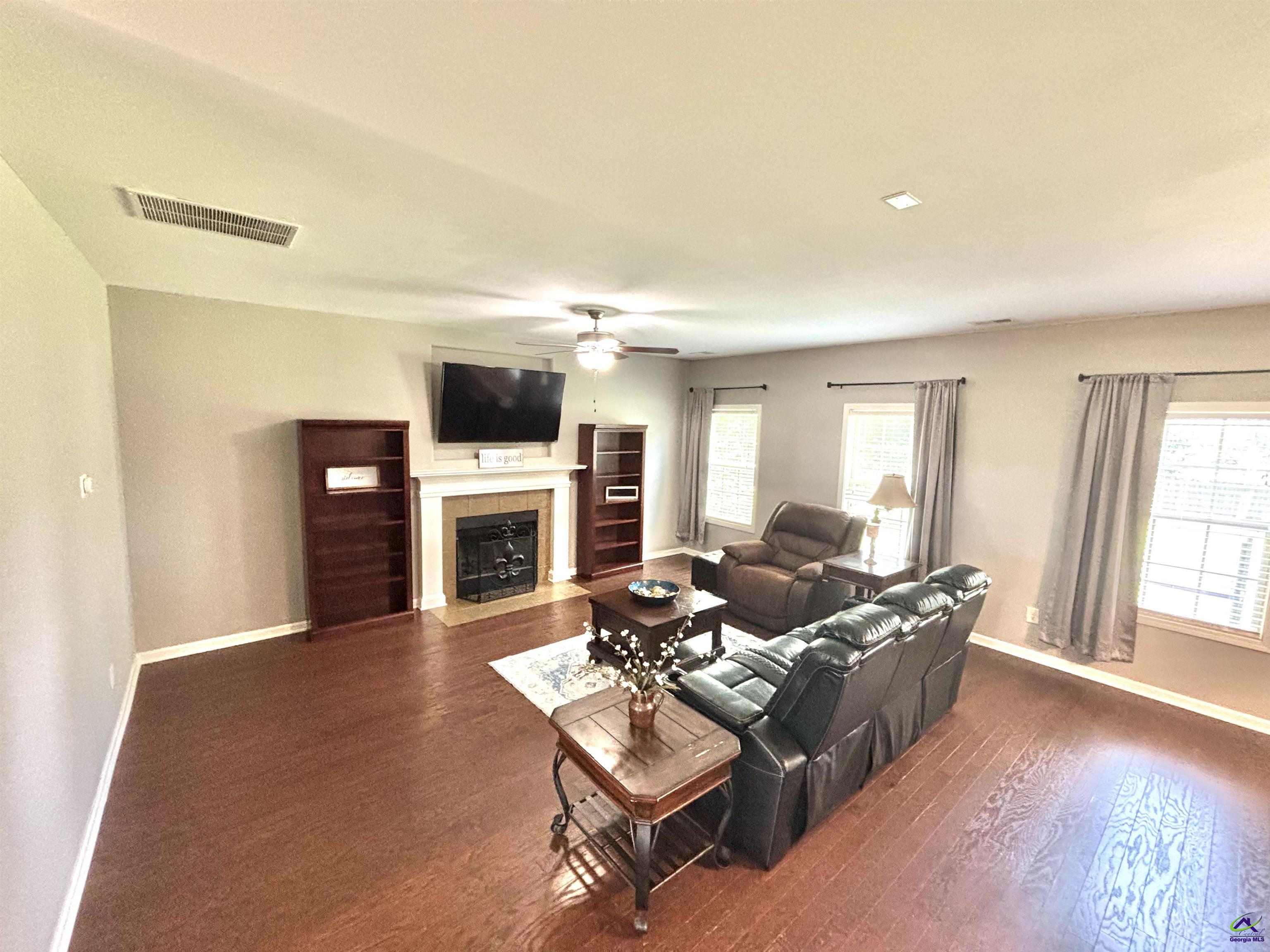 600 Post Oak Way Warner Robins, GA 31088 - Photo 12 of 50 a living room with furniture a fireplace and a flat screen tv