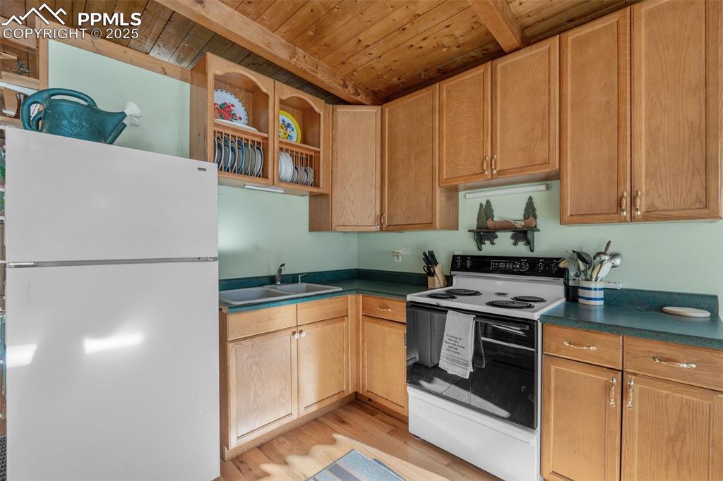 15103 Rainbow Road Sedalia, CO 80135 - Photo 17 of 48 a kitchen with stainless steel appliances granite countertop a refrigerator a stove and a sink