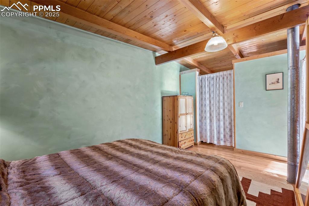 15103 Rainbow Road Sedalia, CO 80135 - Photo 19 of 48 a bedroom with a bed and a window