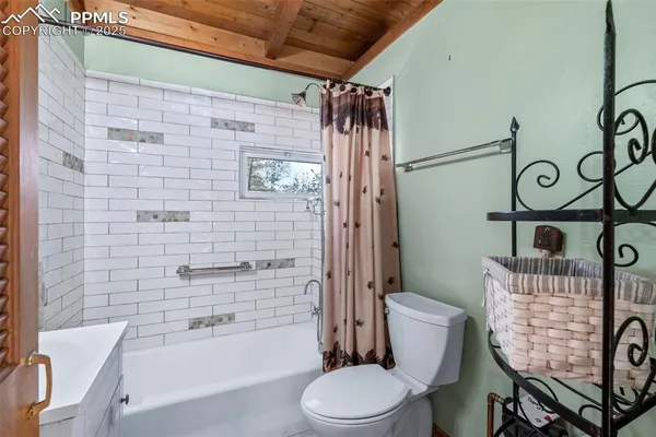 a bathroom with a toilet and shower