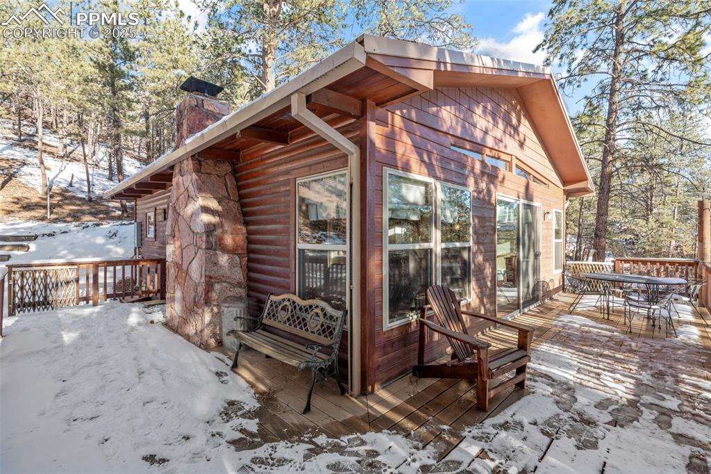 15103 Rainbow Road Sedalia, CO 80135 - Photo 24 of 48 a backyard of a house with barbeque oven table and chairs