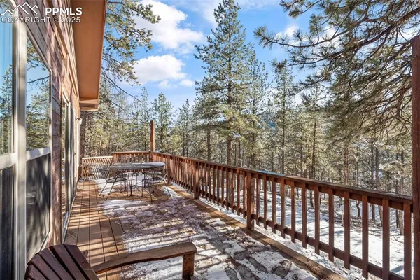a view of balcony with wooden floor and fence