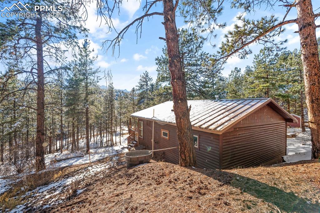 15103 Rainbow Road Sedalia, CO 80135 - Photo 28 of 48 a view of a house with a snow in the yard