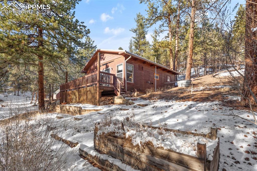 15103 Rainbow Road Sedalia, CO 80135 - Photo 29 of 48 a view of a house with a yard covered in snow