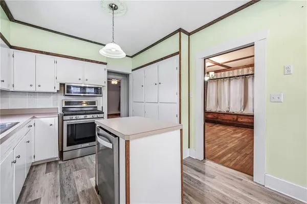 a kitchen with stainless steel appliances granite countertop a refrigerator and a stove top oven