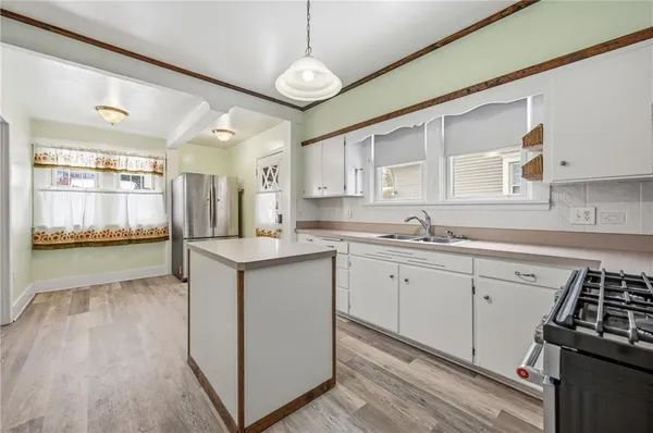 a kitchen with granite countertop white cabinets and white appliances