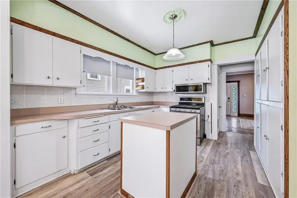 a kitchen with stainless steel appliances granite countertop a stove and cabinets