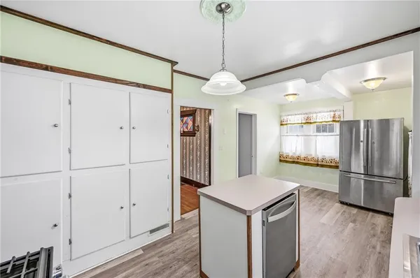 a kitchen with stainless steel appliances granite countertop a refrigerator a sink and a refrigerator