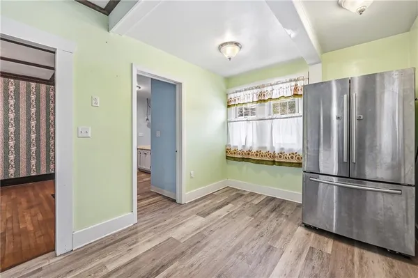 a kitchen with granite countertop wooden floors and stainless steel appliances
