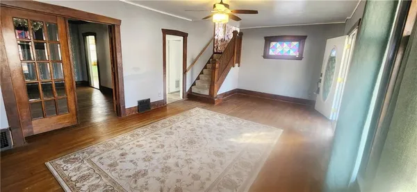 a view of entryway with stairs and wooden floor
