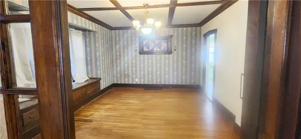 a view of a room with window and hardwood