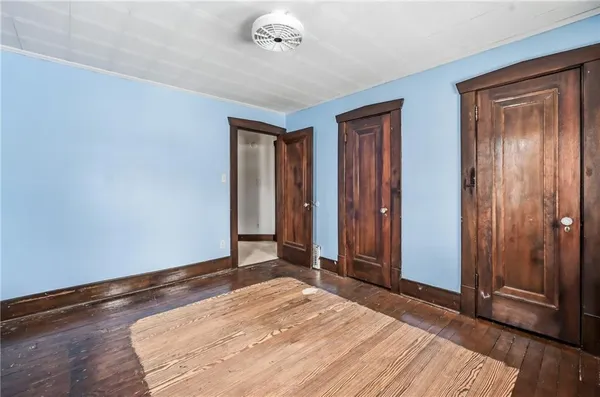 a bedroom with a bed and a mirror