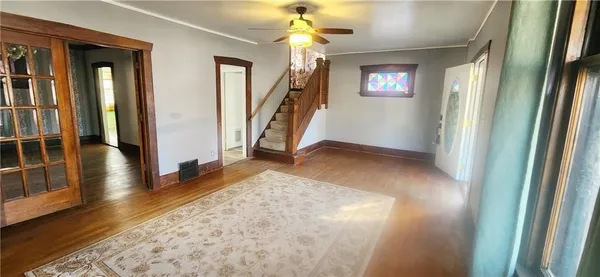 wooden floor in an empty room with a window
