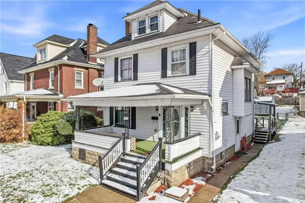 a view of a white building among the front of the house