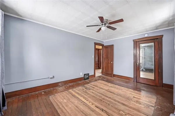 a view of empty room with window and ceiling fan