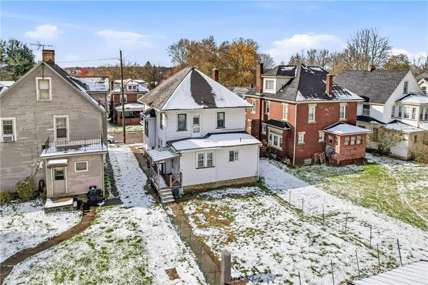 a aerial view of a house with a yard