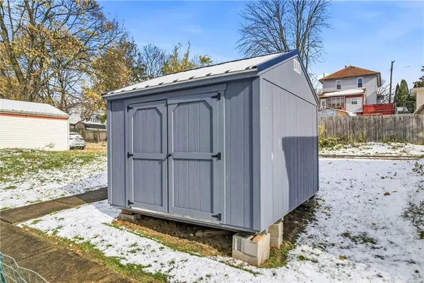 a view of a house with a wooden fence