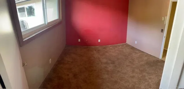 a view of a house with a wooden fence