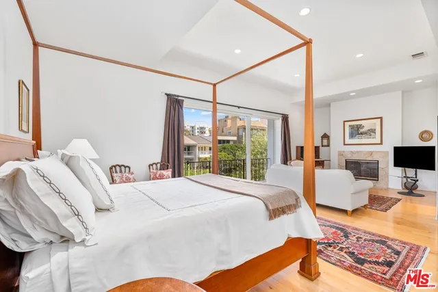 a bedroom with a bed couch and window