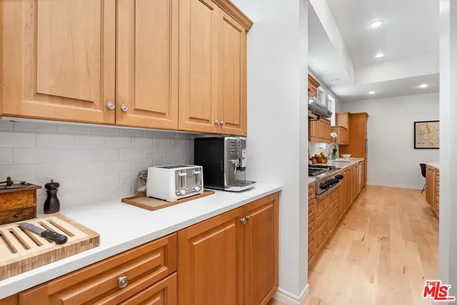 a kitchen with stainless steel appliances a stove a sink and a refrigerator