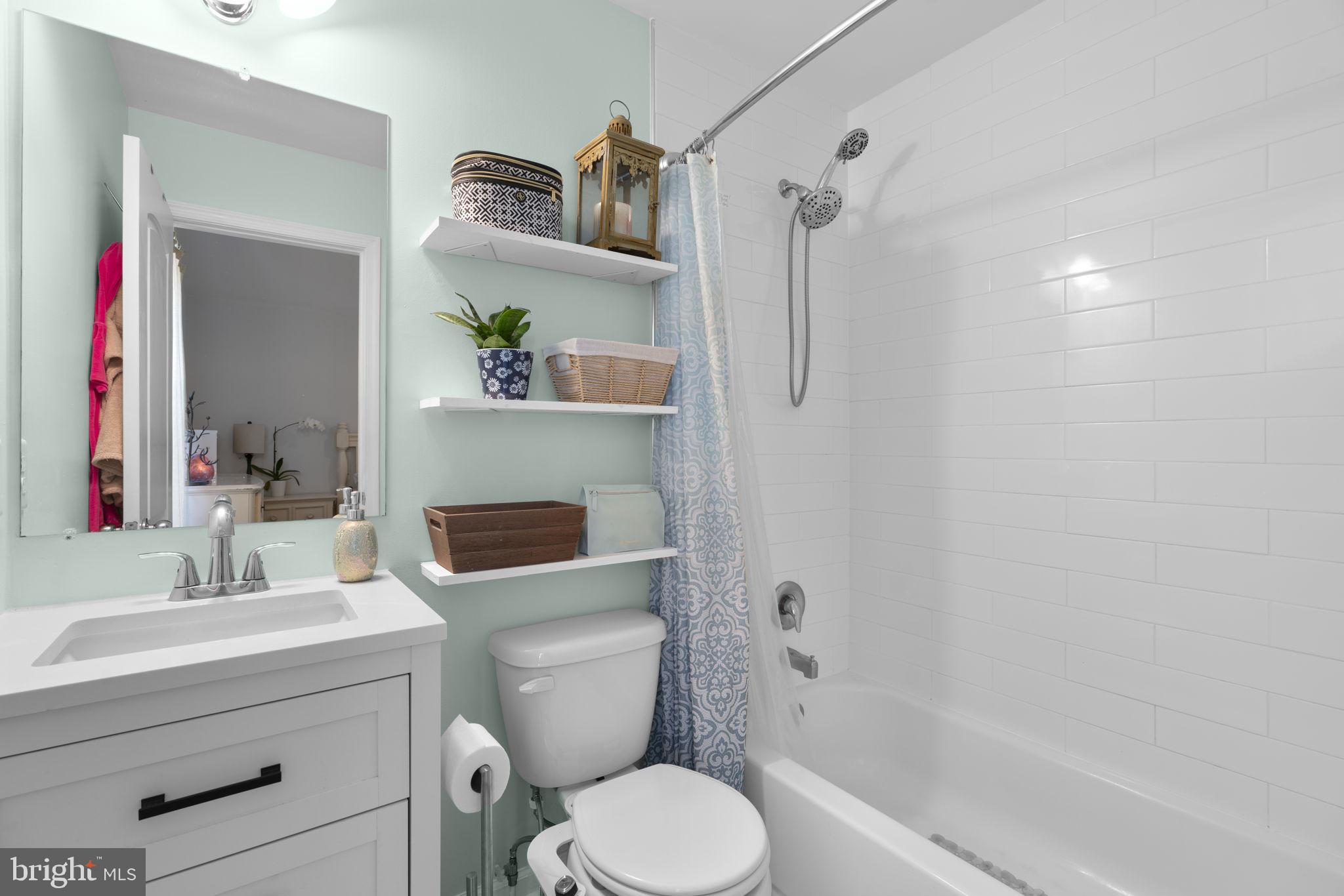 465 Carvel Beach Road Carvel Beach, MD 21226 - Photo 11 of 30 a bathroom with a granite countertop toilet sink and shower