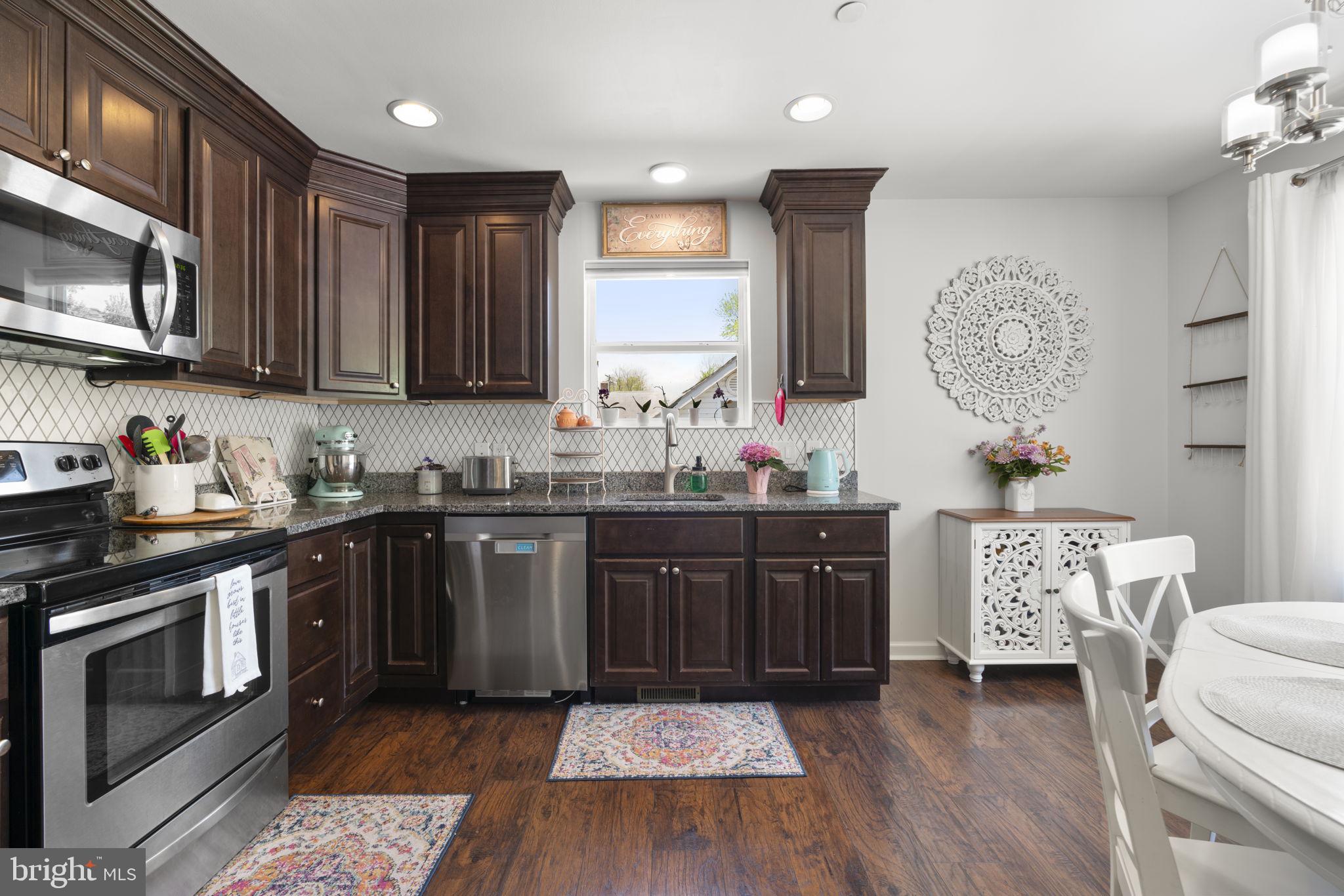 465 Carvel Beach Road Carvel Beach, MD 21226 - Photo 5 of 30 a kitchen with a sink stove and microwave