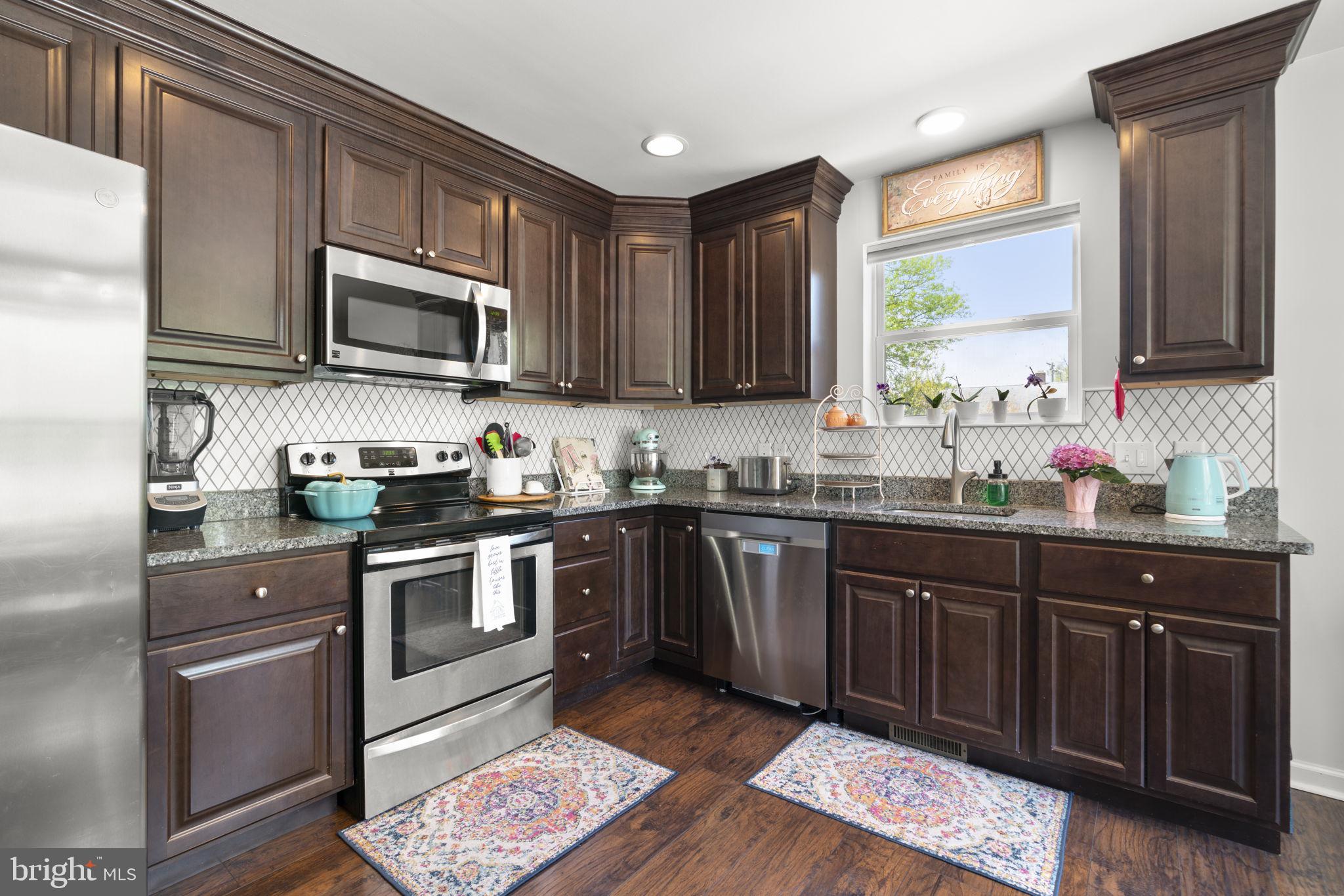 465 Carvel Beach Road Carvel Beach, MD 21226 - Photo 6 of 30 a kitchen with stainless steel appliances granite countertop a sink a stove a microwave and cabinets