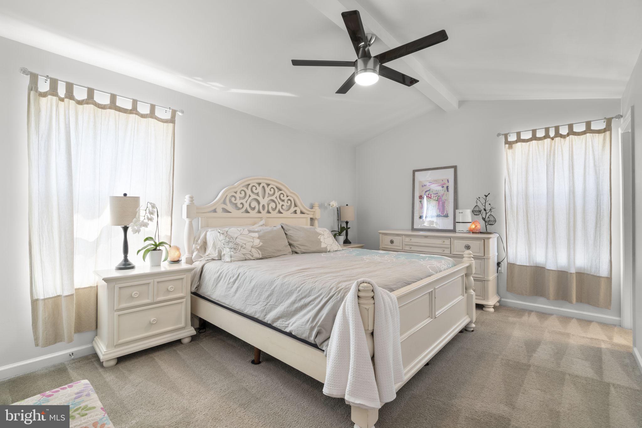 465 Carvel Beach Road Carvel Beach, MD 21226 - Photo 9 of 30 a bedroom with a bed and a chandelier