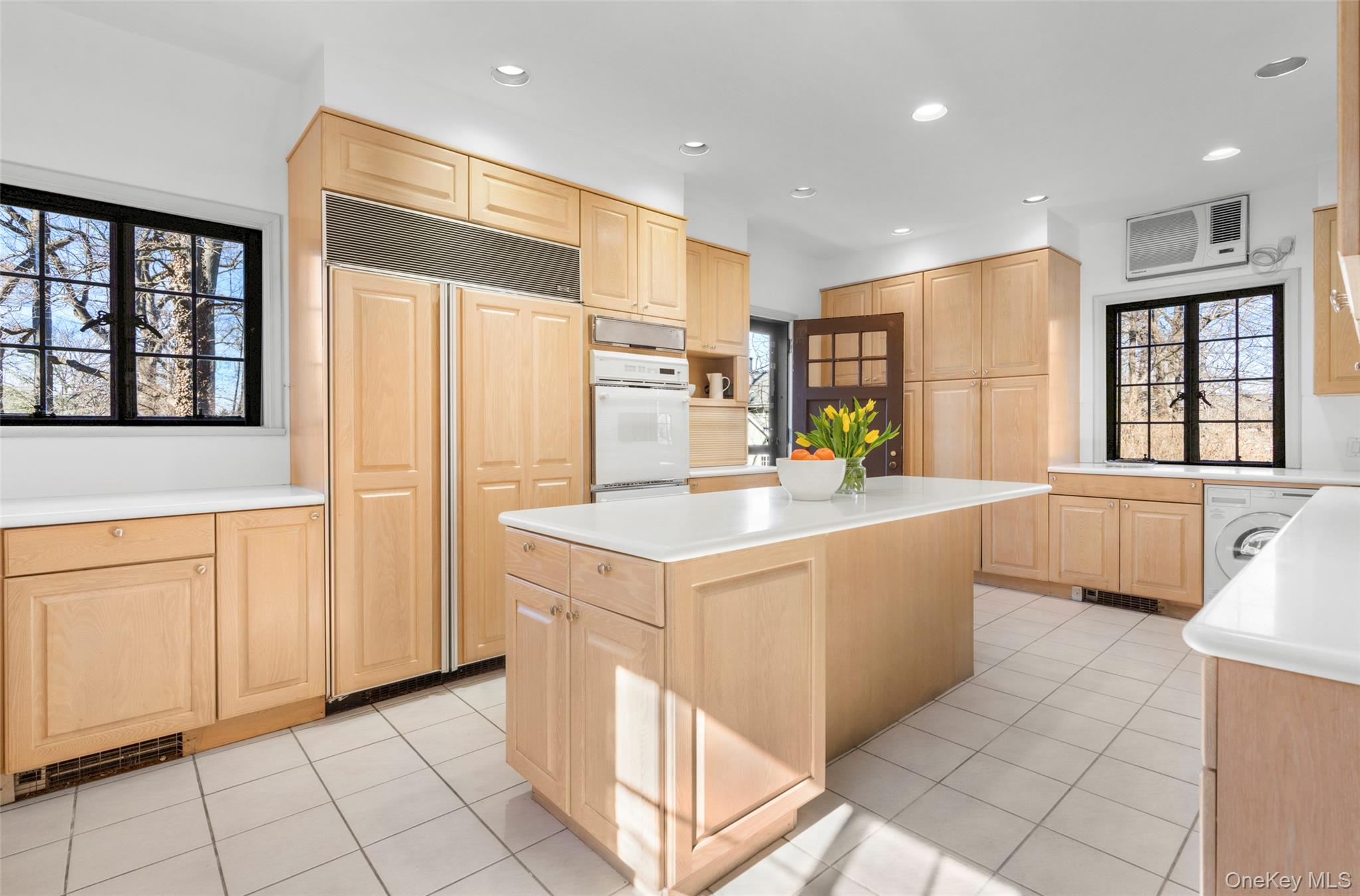 60 Wildwood Road New Rochelle, NY 10804 - Photo 17 of 49 a kitchen with stainless steel appliances kitchen island granite countertop a refrigerator a sink and white cabinets