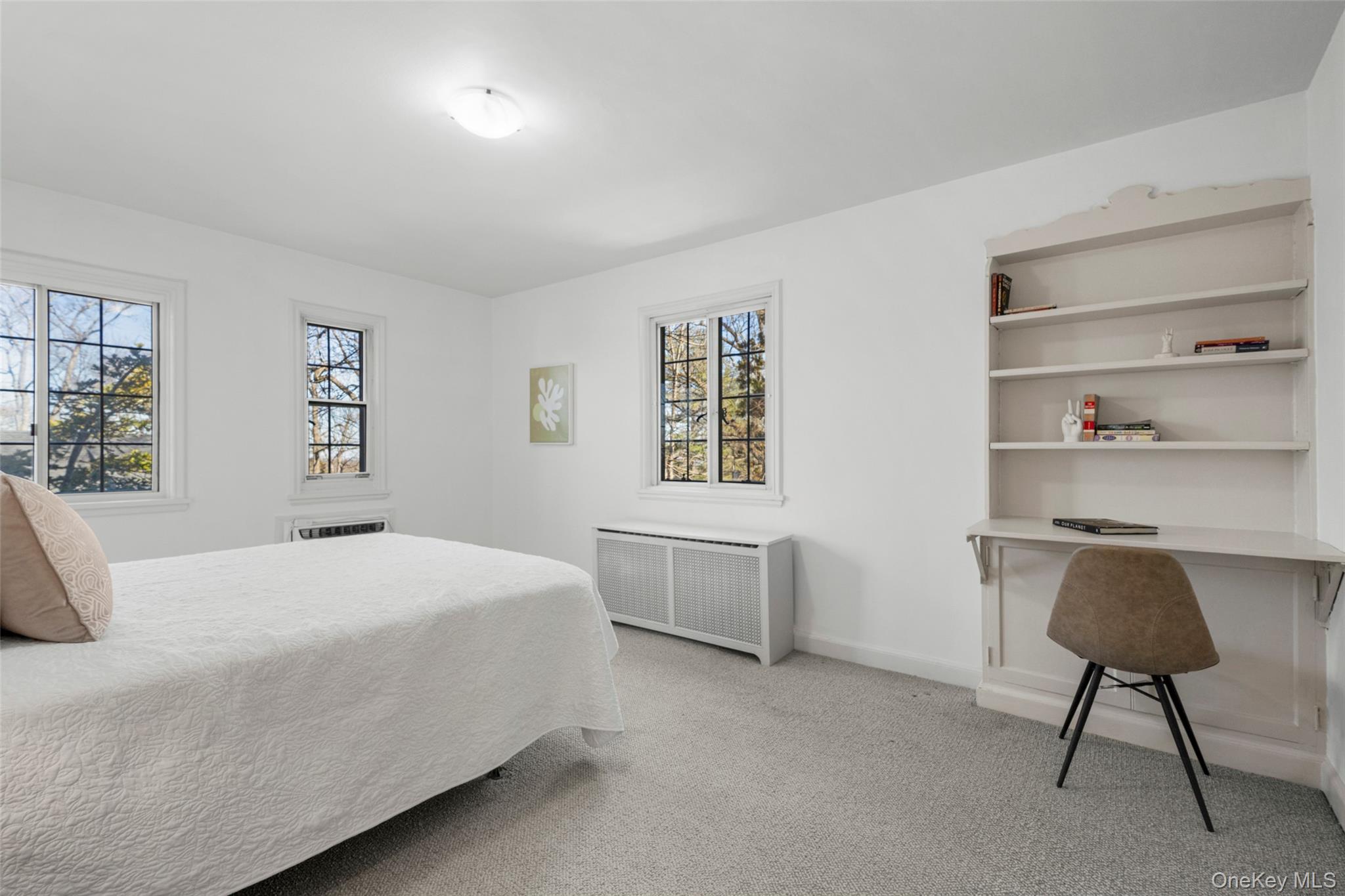 60 Wildwood Road New Rochelle, NY 10804 - Photo 27 of 49 a bedroom with a bed a desk and painting on the wall