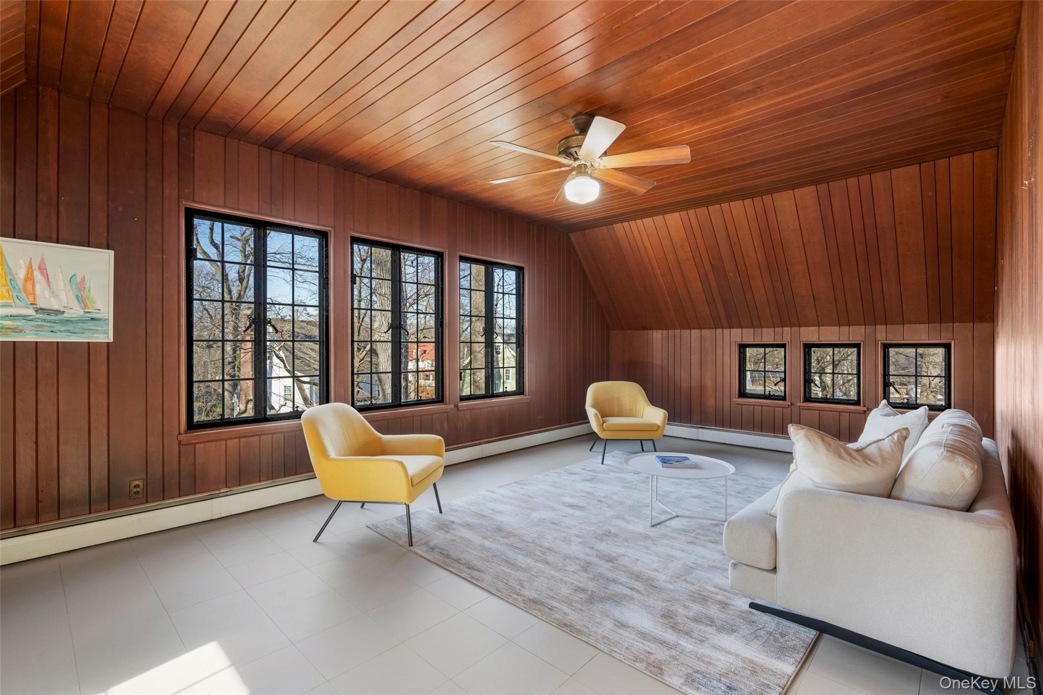 60 Wildwood Road New Rochelle, NY 10804 - Photo 30 of 49 a living room with furniture and a chandelier