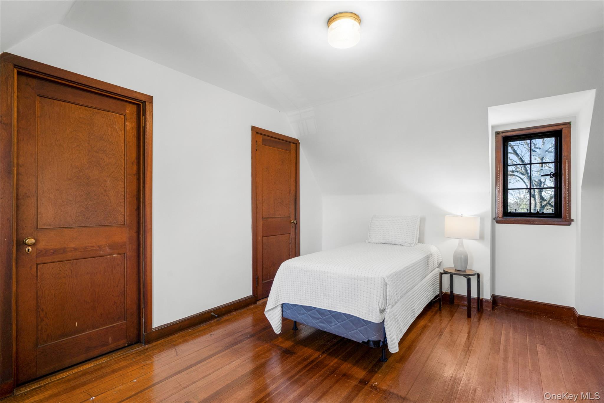 60 Wildwood Road New Rochelle, NY 10804 - Photo 34 of 49 a bedroom with a bed and wooden floor