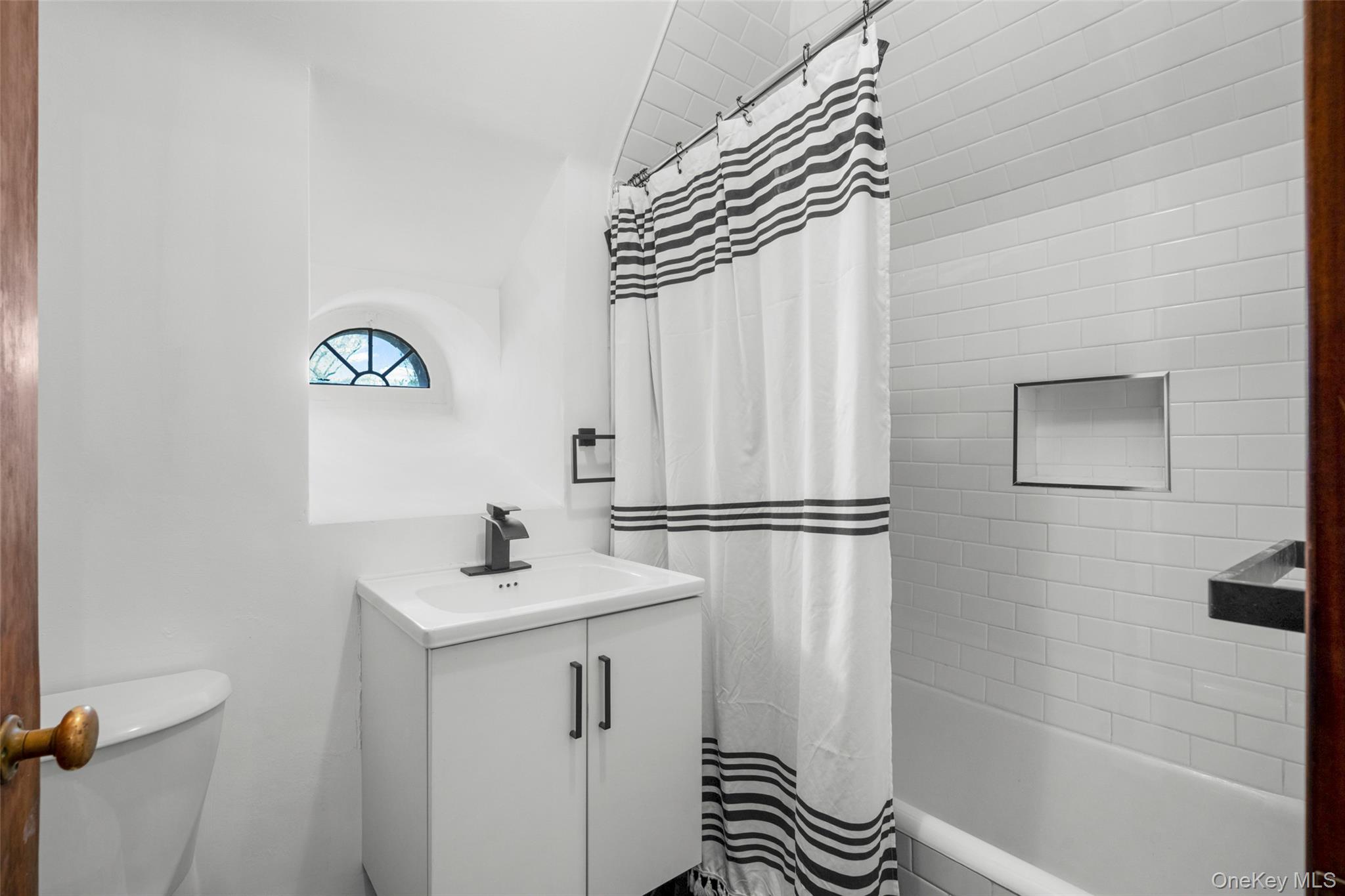 60 Wildwood Road New Rochelle, NY 10804 - Photo 35 of 49 a bathroom with a sink a mirror and a shower