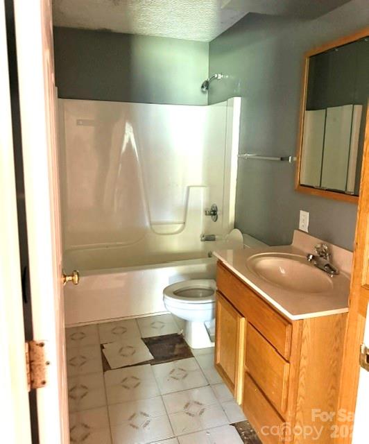 4084 Carpenters Cove Road Claremont, NC 28610 - Photo 23 of 27 a bathroom with a sink a toilet and a bathtub