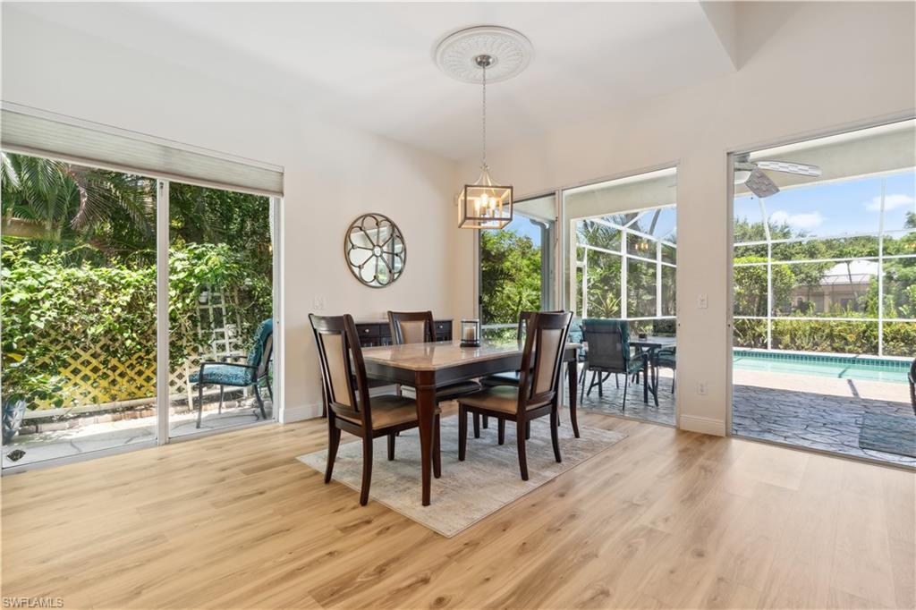 5049 Fairhaven Lane Naples, FL 34109 - Photo 12 of 46 a view of a dining room with furniture window and wooden floor