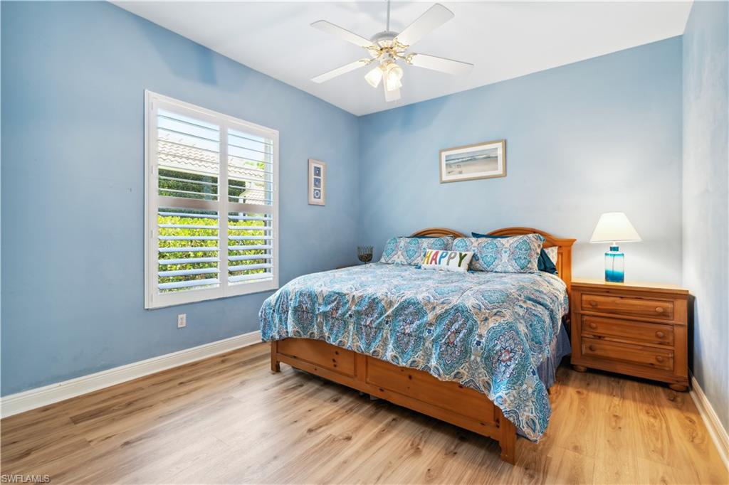 5049 Fairhaven Lane Naples, FL 34109 - Photo 13 of 46 a bedroom with a bed and a chandelier