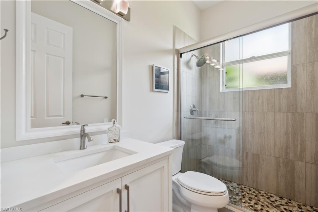 5049 Fairhaven Lane Naples, FL 34109 - Photo 14 of 46 a bathroom with a sink a toilet and shower