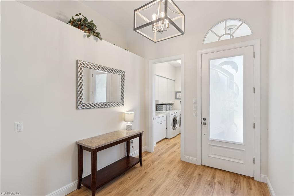 5049 Fairhaven Lane Naples, FL 34109 - Photo 20 of 46 a view of hallway with wooden floor and cabinet