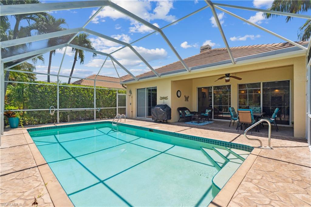 5049 Fairhaven Lane Naples, FL 34109 - Photo 23 of 46 a view of a backyard with a patio and a garden