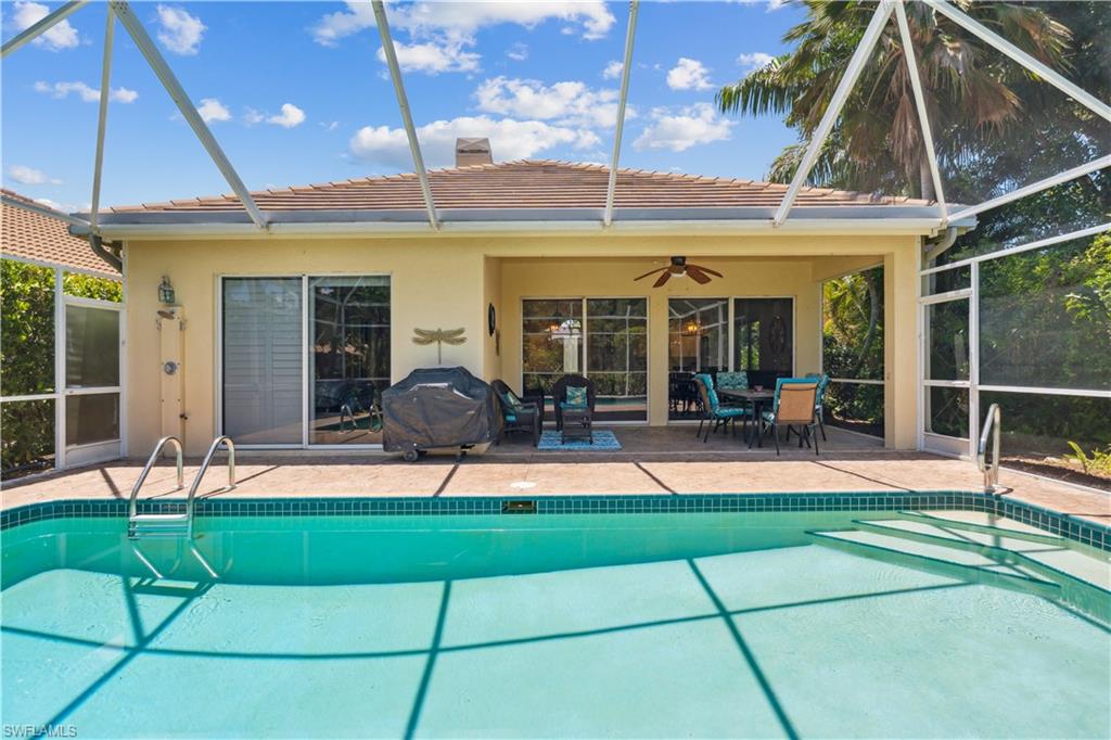 5049 Fairhaven Lane Naples, FL 34109 - Photo 24 of 46 a view of a house with a backyard porch and sitting area
