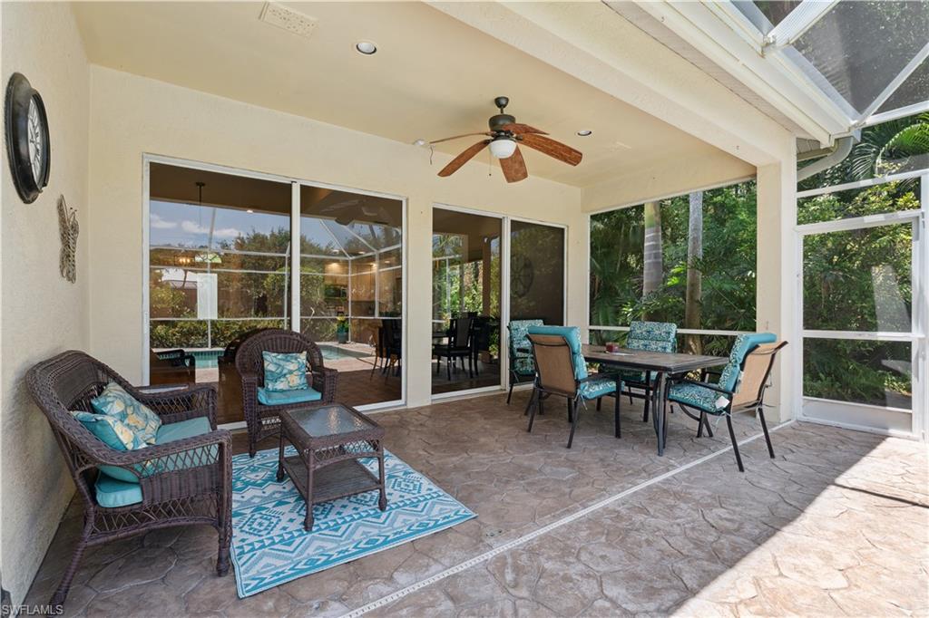 5049 Fairhaven Lane Naples, FL 34109 - Photo 26 of 46 a dining room with wooden floor and a rug