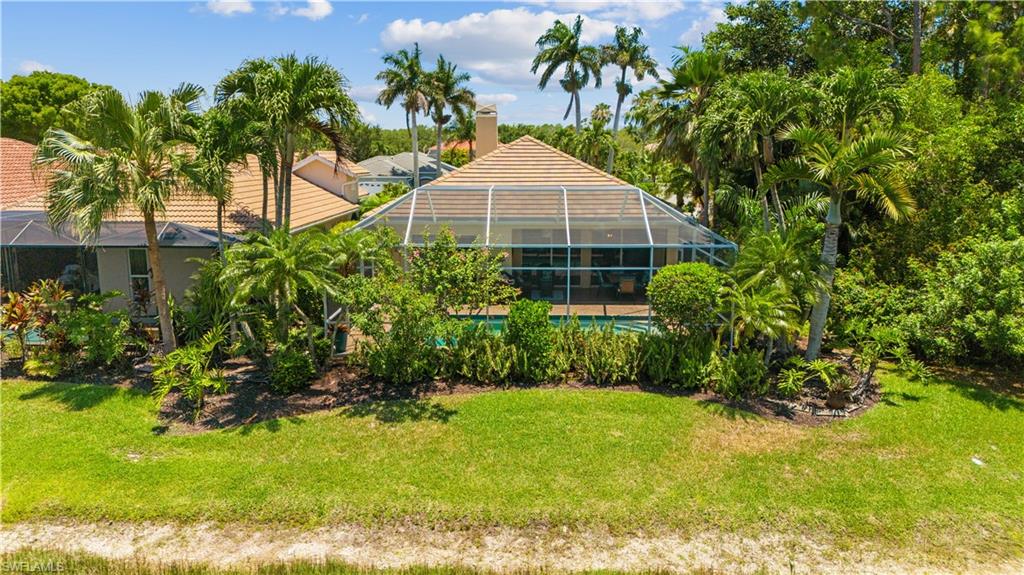 5049 Fairhaven Lane Naples, FL 34109 - Photo 27 of 46 a front view of a house with a yard and potted plants