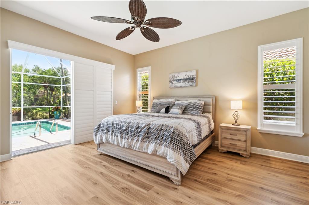 5049 Fairhaven Lane Naples, FL 34109 - Photo 3 of 46 a bedroom with a large bed and a large window