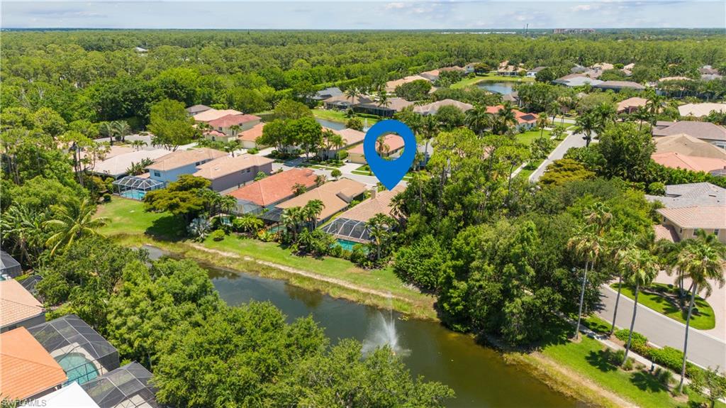 5049 Fairhaven Lane Naples, FL 34109 - Photo 31 of 46 a view of a lake with a house