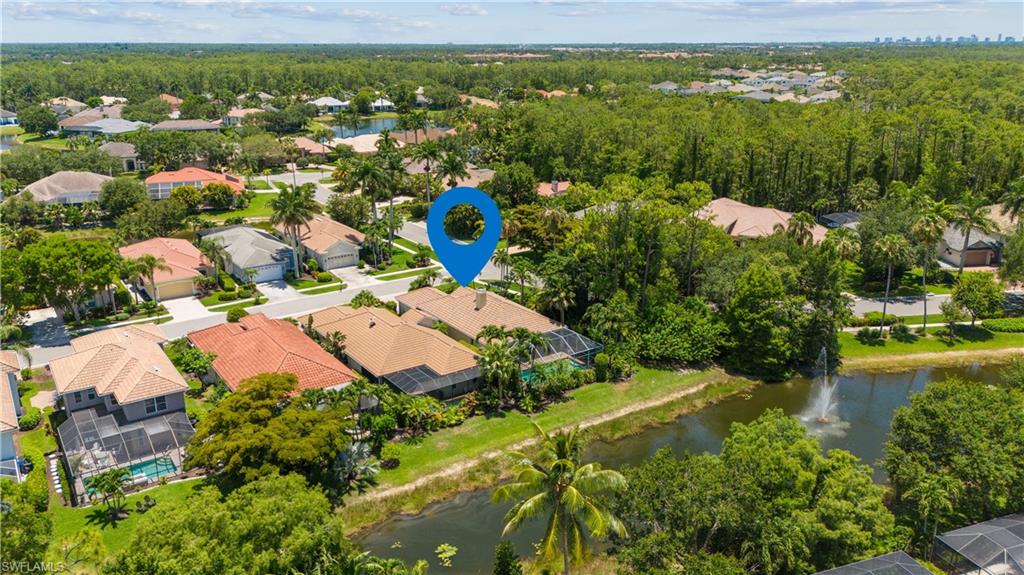 5049 Fairhaven Lane Naples, FL 34109 - Photo 32 of 46 a view of a lake with a house
