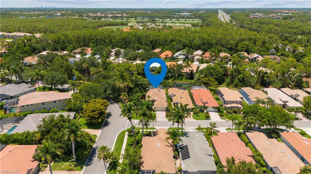 5049 Fairhaven Lane Naples, FL 34109 - Photo 33 of 46 an aerial view of lake residential house with outdoor space and garden view